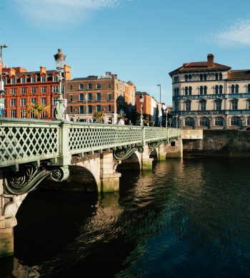 A Beautiful Sunny Day at the Green Bridge Over the River in Dublin City